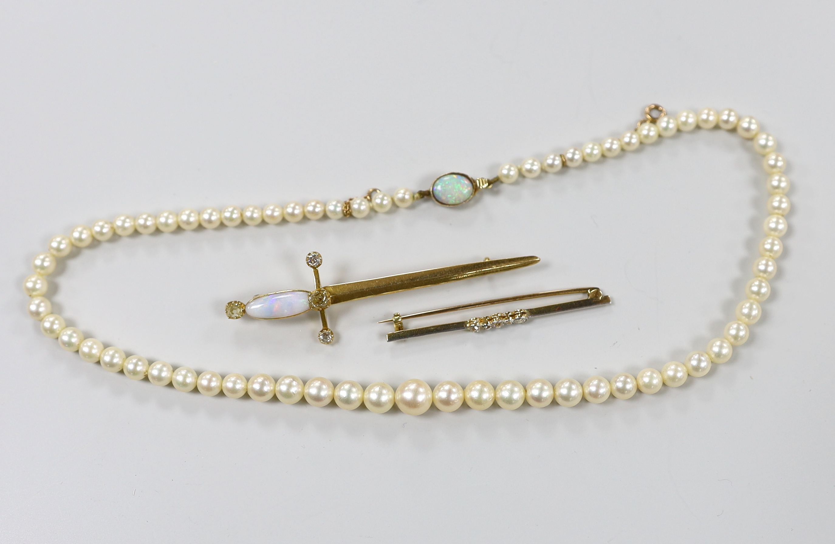 An early 20th century diamond set gold bar brooch, a cultured pearl necklace and a sword shaped brooch